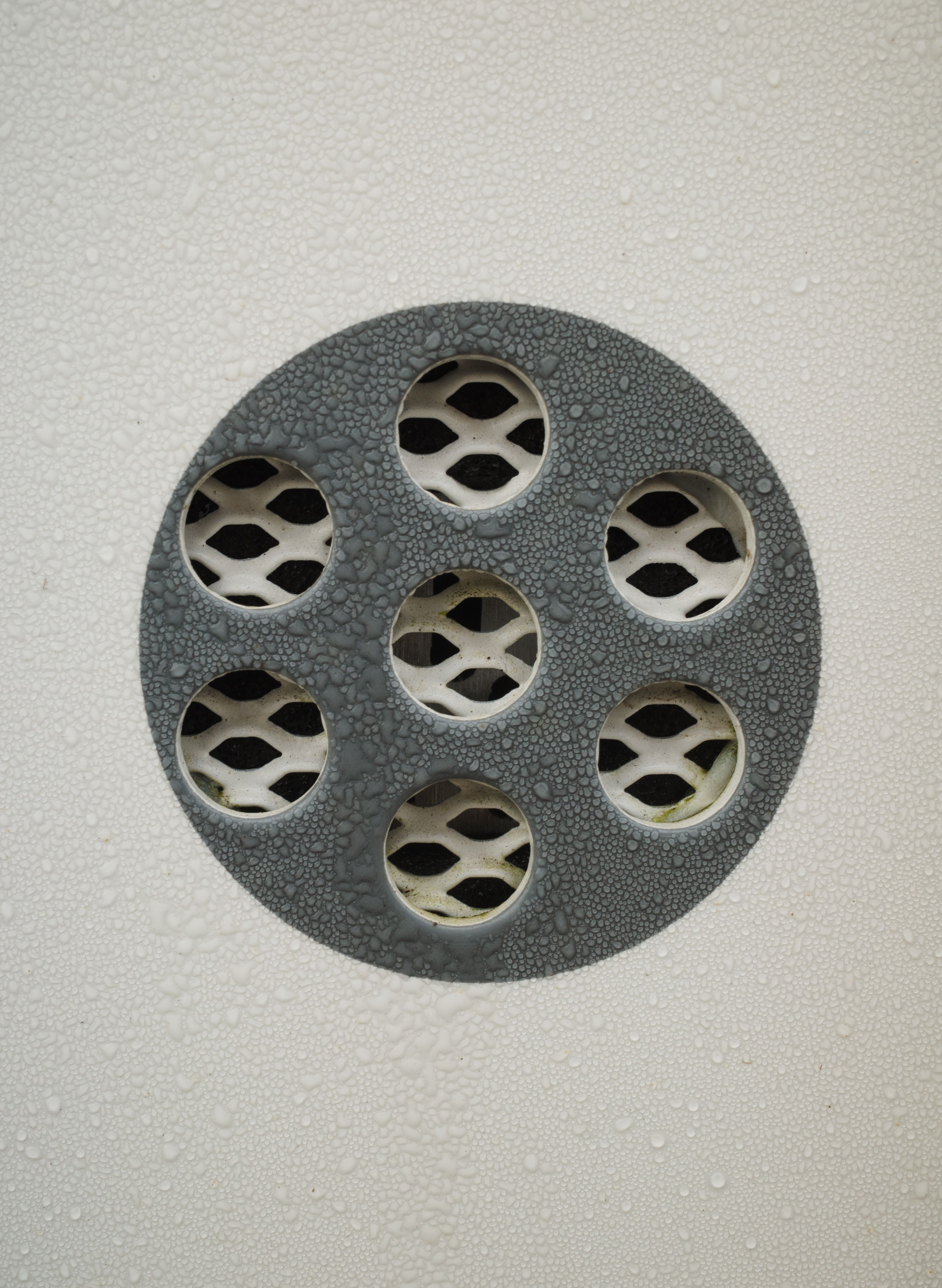 Water droplets around a household drain cover